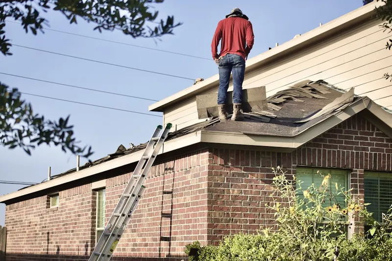 Professional roofer working on a residential roof in East St. Louis